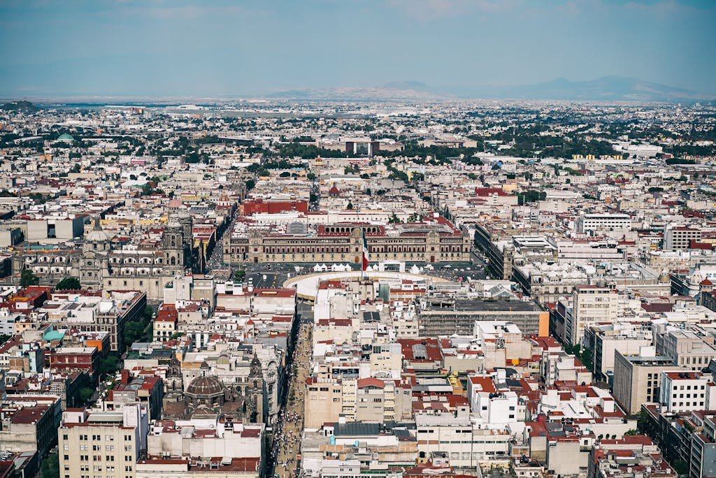 Aerial view capturing the sprawling urban landscape of Mexico City with historic architecture.