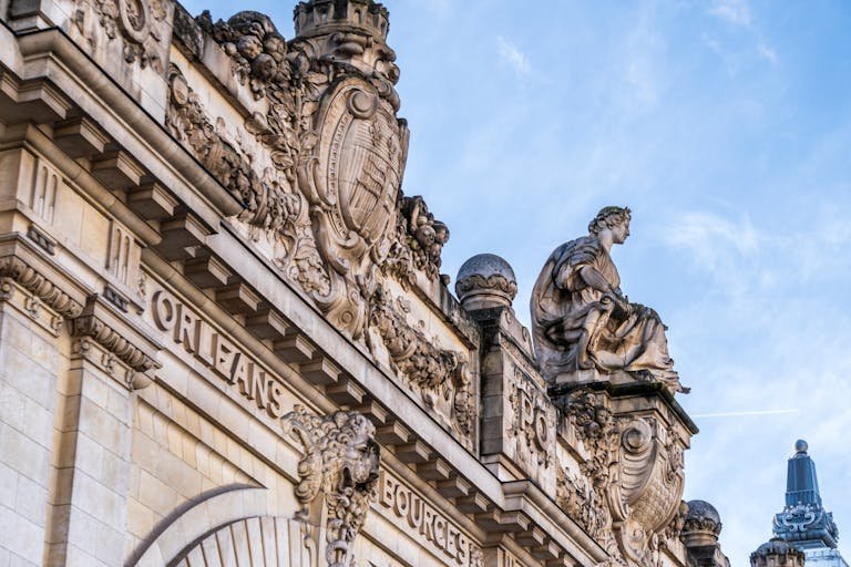 Classic Parisian architecture featuring intricate sculptures and ornate details.