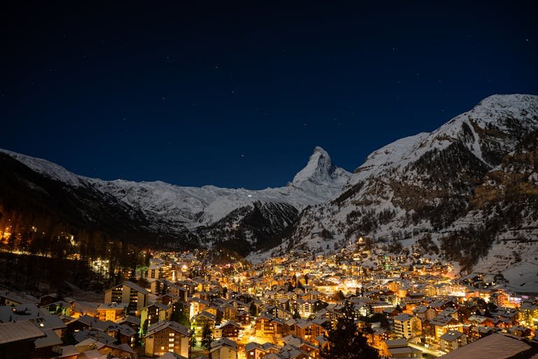 Stunning nightscape of Zermatt with the illuminated Matterhorn and village lights in Switzerland.