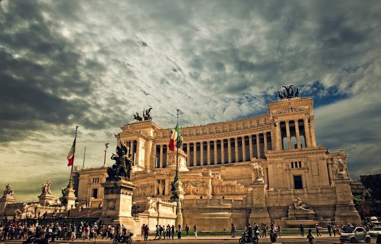 Stunning view of the Victor Emmanuel II Monument in Rome under dramatic skies.