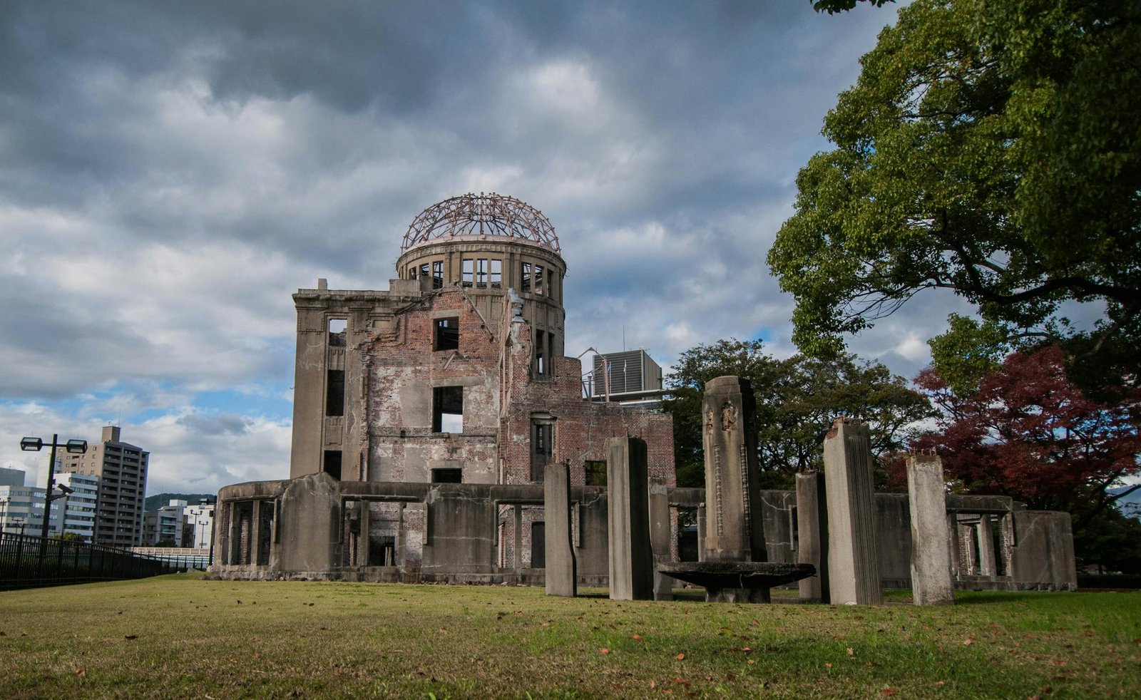 The iconic Hiroshima Peace Memorial Dome against a cloudy sky in Hiroshima, Japan.