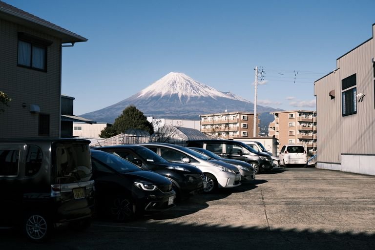Captured in Fuji, Shizuoka with Mount Fuji in the backdrop and a parking lot scene.