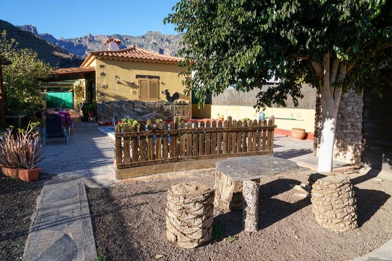 Exterior of aged house located in countryside under blue sky in sunny summer day